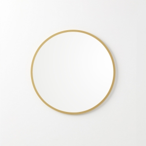 Matte gold rubber framed round mirror hanging on beige wall