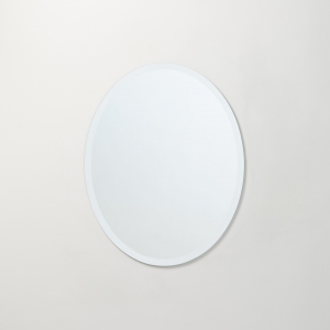Frameless beveled oval copper-free mirror hanging on beige wall
