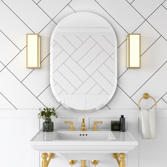 Frameless beveled racetrack oval mirror hanging on wallpaper wall above bathroom vanity