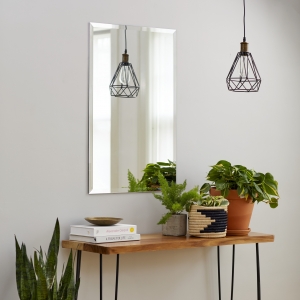 Frameless beveled rectangle mirror copper-free hanging on wall above side table