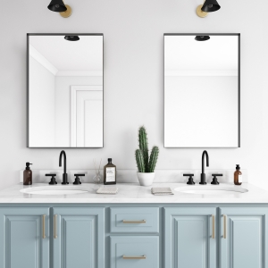 Black metal framed rectangle mirrors hanging on bathroom wall above double sink vanity