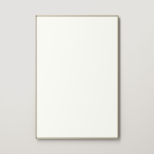 Gold metal framed rectangle mirror hanging on beige wall