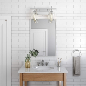 Silver metal framed rectangle hanging on bathroom wall above single sink vanity