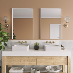 White metal framed rectangle mirrors hanging on bathroom wall above double sink vanity