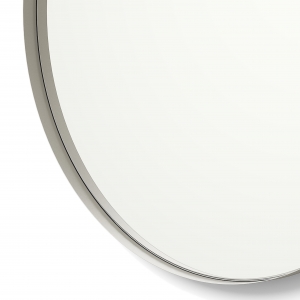 Close-up angle shot of nickel framed round mirror