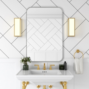 White metal framed rounded rectangle mirror hanging on bathroom wall above single sink vanity