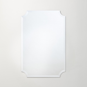 Frameless beveled scalloped rectangle mirror hanging on beige wall